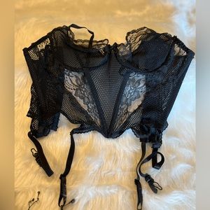 Black bustiers with garter straps.